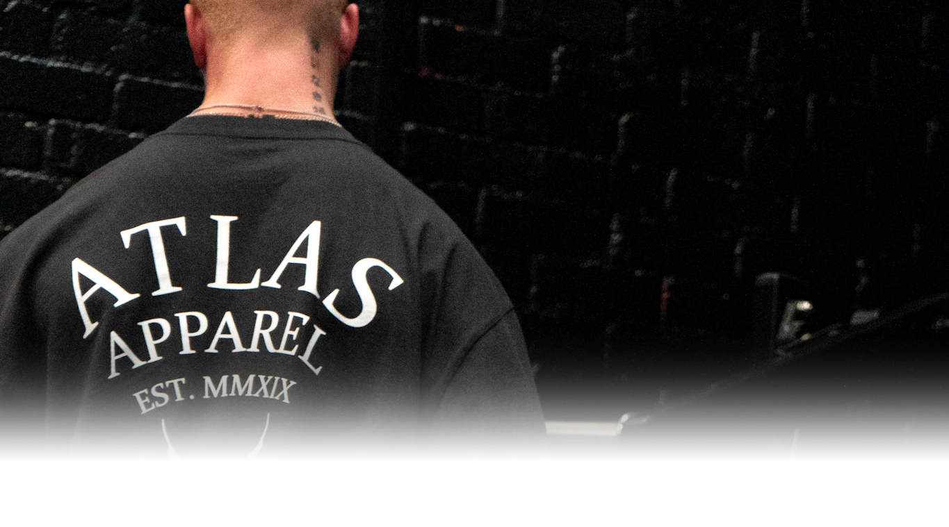 The back of a male athlete wearing the Atlas Apparel legacy oversized tee.