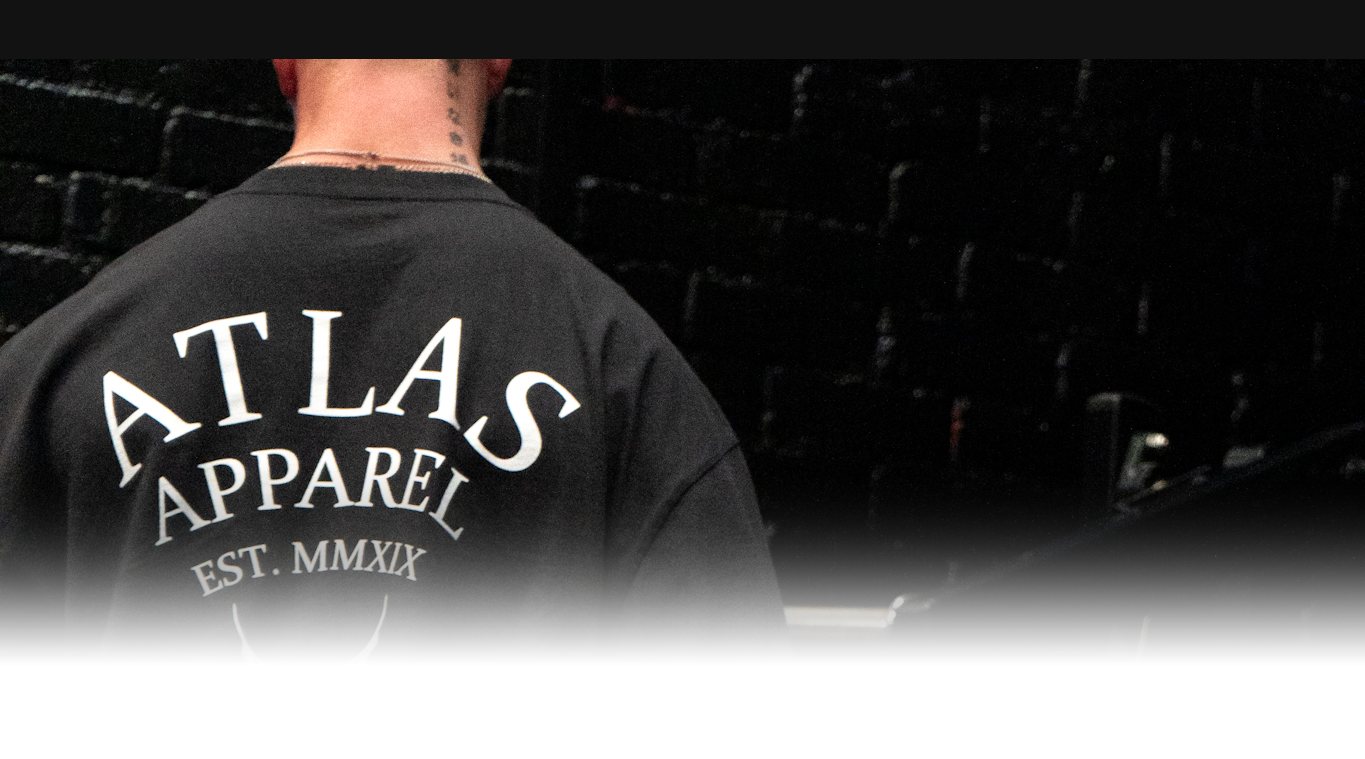 The back of a male athlete wearing the Atlas Apparel legacy oversized tee.